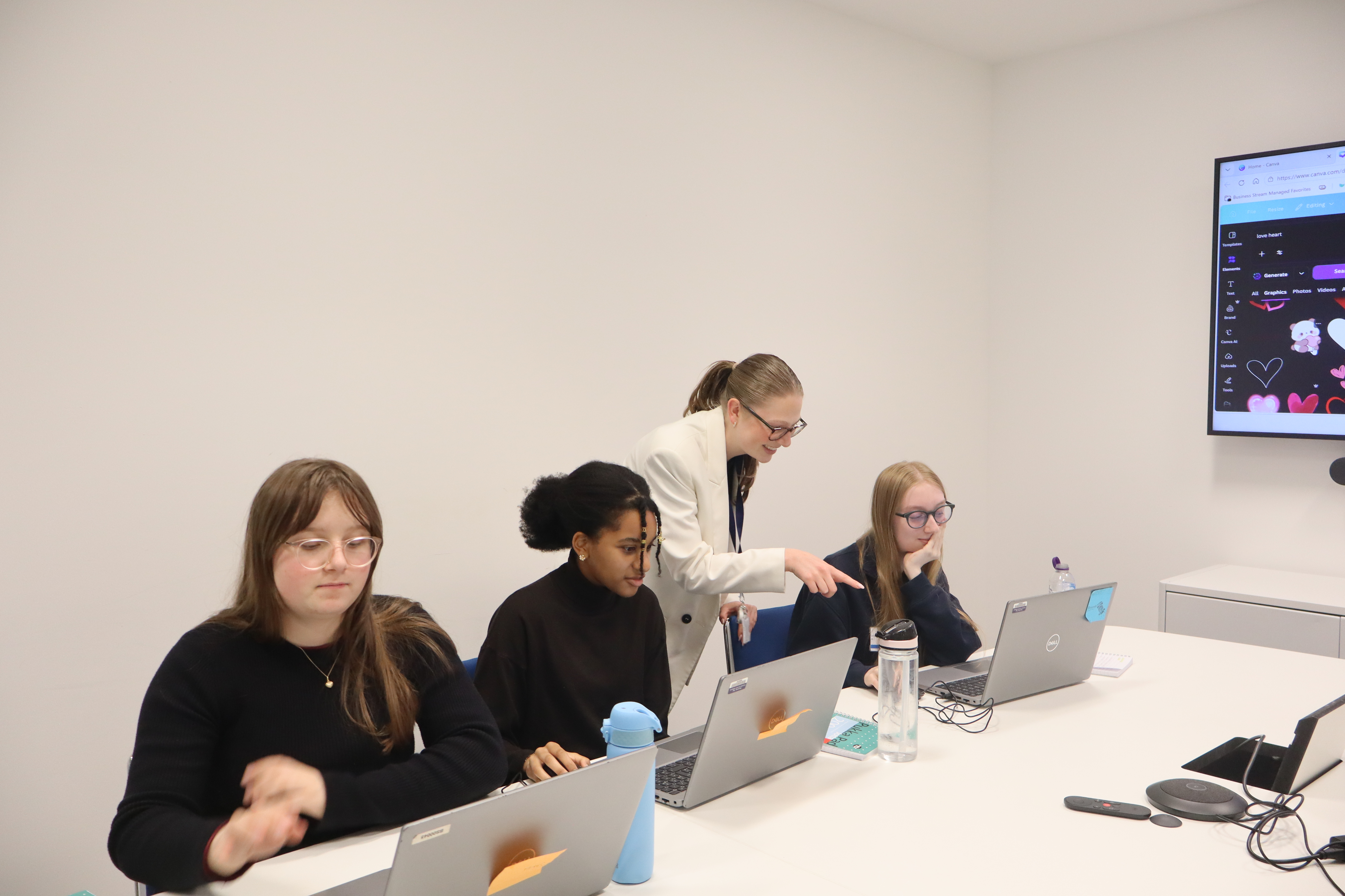 Career ready students in meeting room looking at laptops
