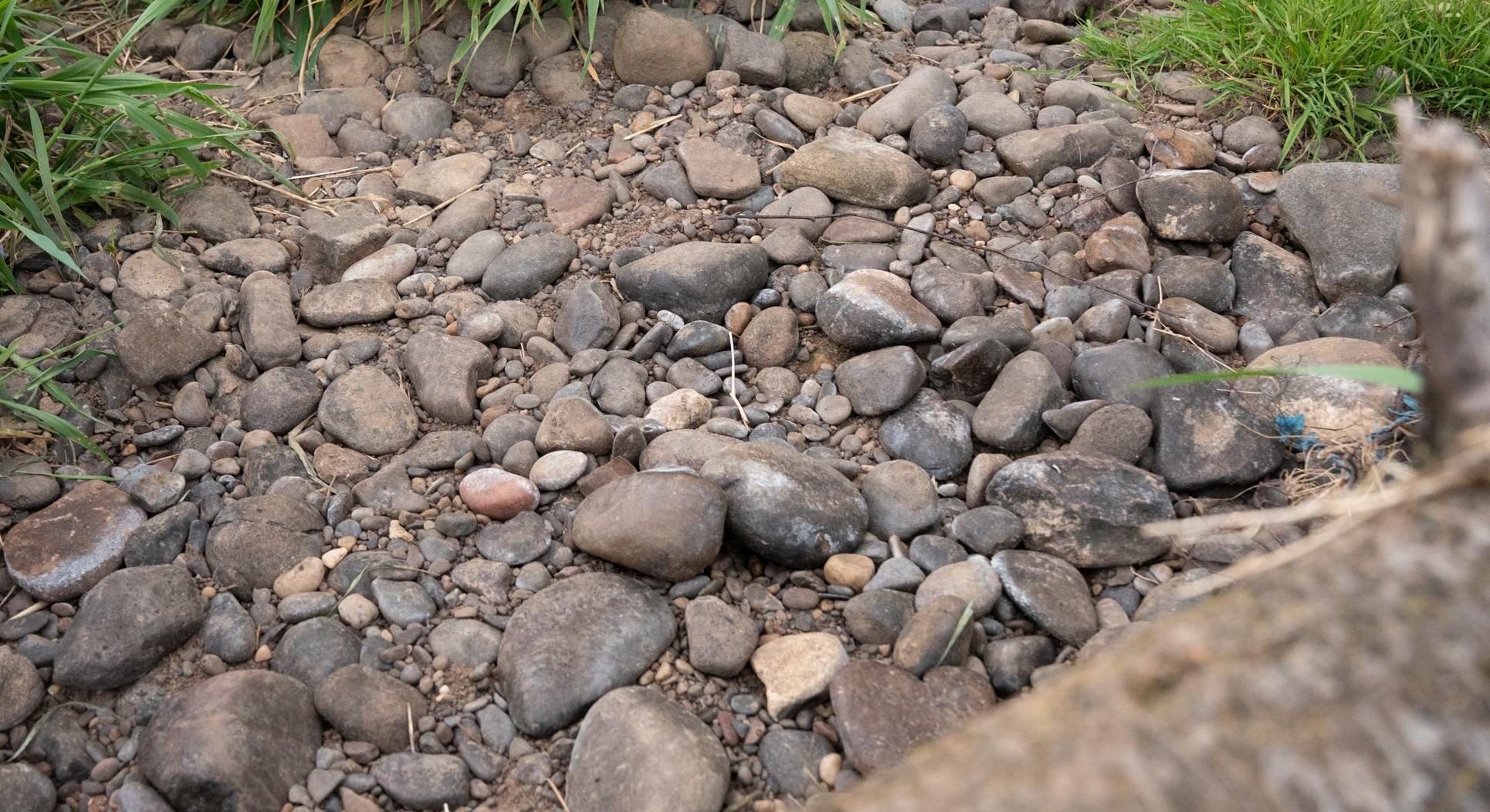Rocks and pebbles at the bottom of a dried up stream