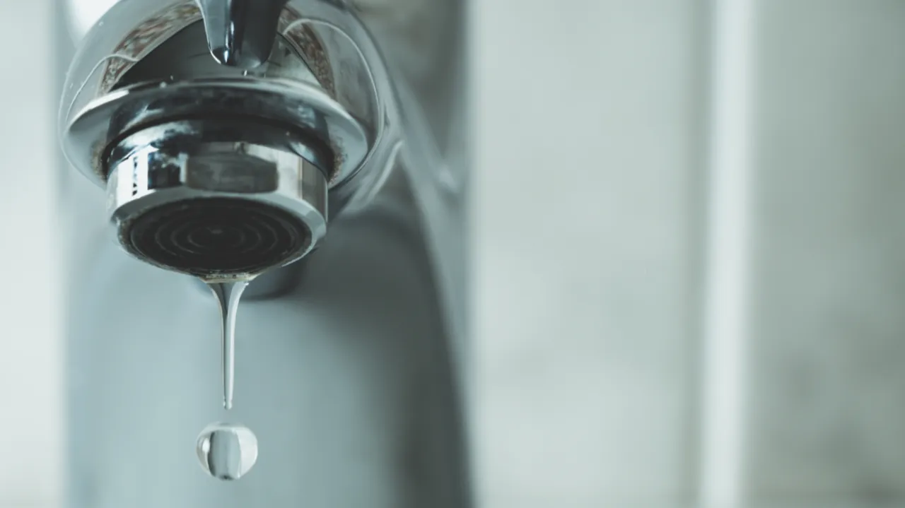 Close up of dripping silver tap