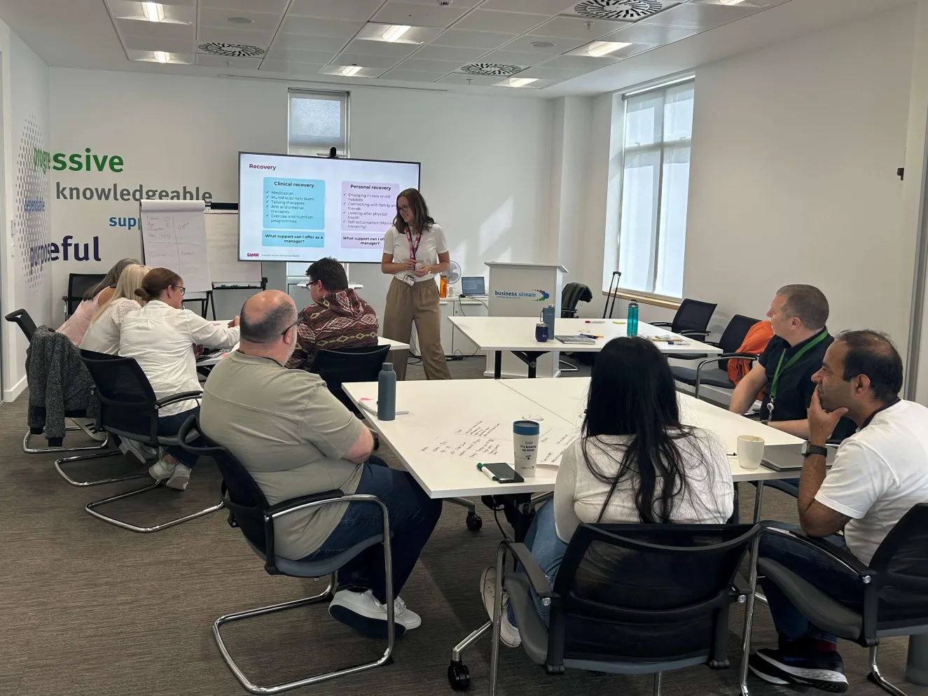 Group of colleagues in conference room taking part in group discussion