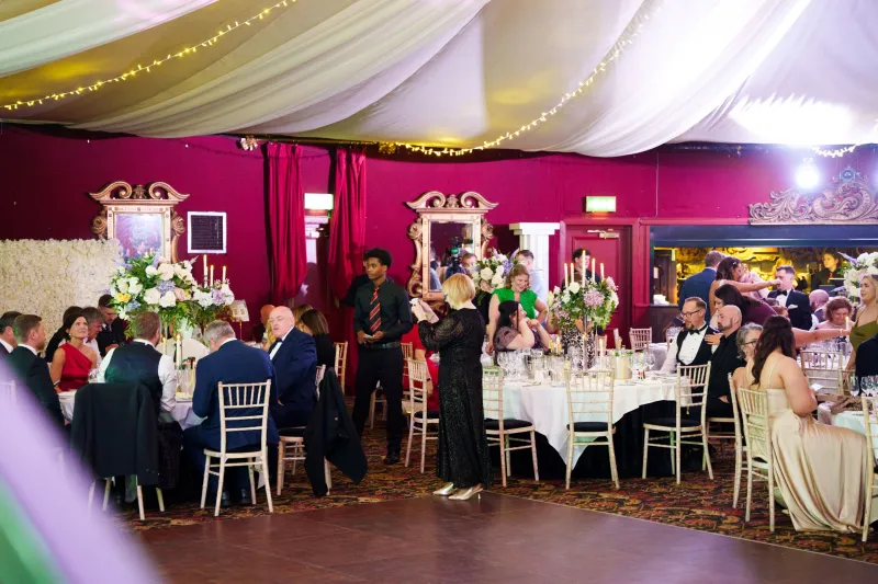 Business Stream colleagues celebrating in festive dinner surroundings at Awards Night