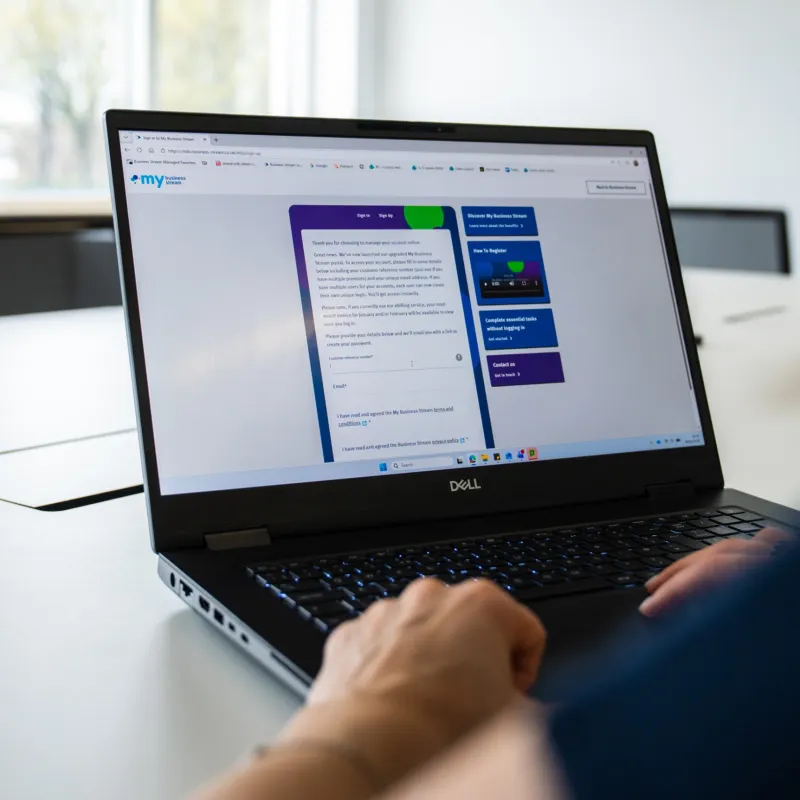 Over-the-shoulder view of laptop showing sign-in screen for My Business Stream