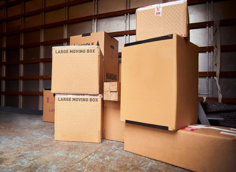 A stack of cardboard removals boxes in a truck