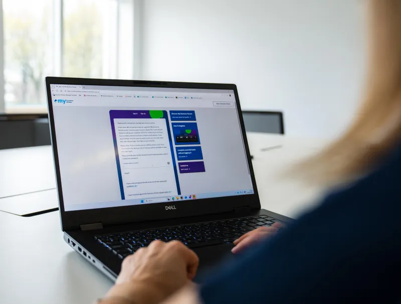 Over the shoulder of a woman at a laptop