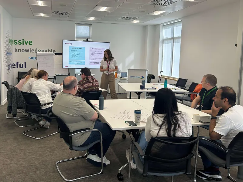 Group of colleagues in conference room taking part in group discussion