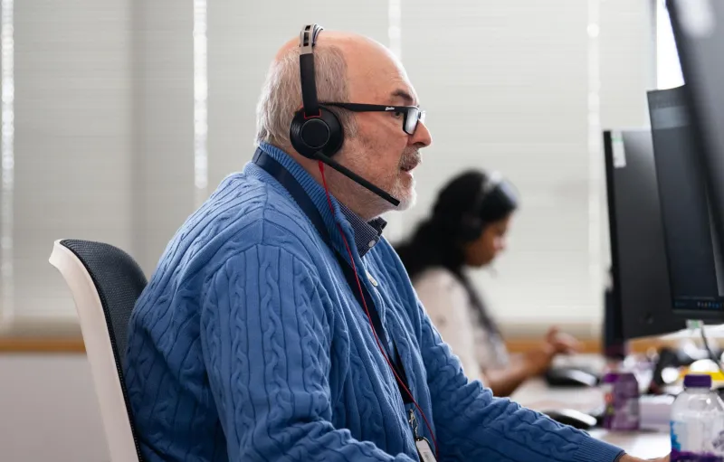 Man wearing headset advising a customer